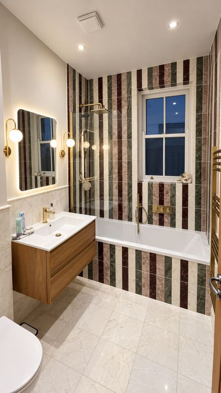 Bathroom with striped marble tiles, bath, walk-in shower and oak vanity