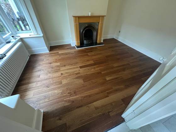 Wood flooring in a living room with fireplace