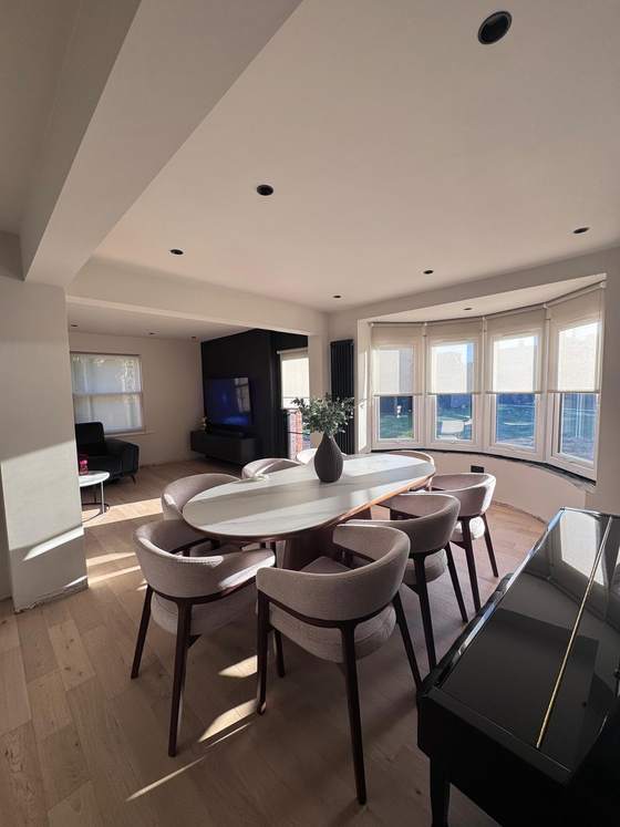 Open-plan dining room with bay window