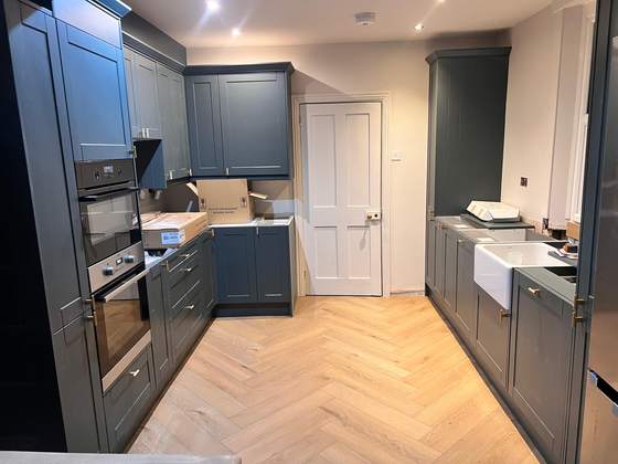 Navy kitchen with herringbone floor